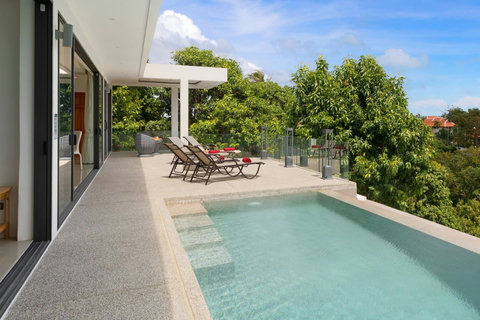 Covered terrace with private pool and tropical garden views - seamless indoor-outdoor living at its finest