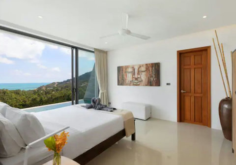 King size master bedroom with floor-to-ceiling windows and stunning hillside views - 1 of 4 luxurious seaview bedrooms