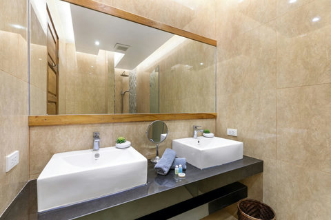 Spacious bathroom with double vanity, premium finishes and ample storage for guest convenience