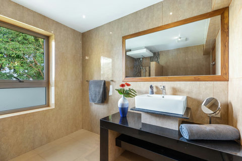 Bright bathroom with garden window, modern vanity and premium fixtures throughout