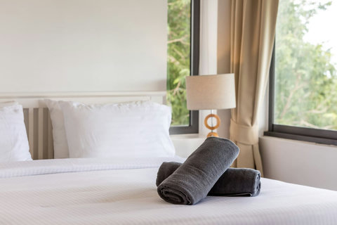 Luxurious private en-suite bathroom with soaking tub, modern amenities and garden views