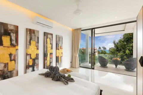 Open-plan living space with decorative Asian screens, modern furniture and seamless indoor-outdoor flow to the pool terrace