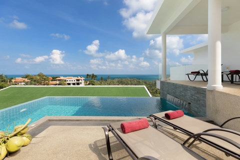 Luxurious pool deck with sun loungers, covered sala and panoramic Chaweng coastline views