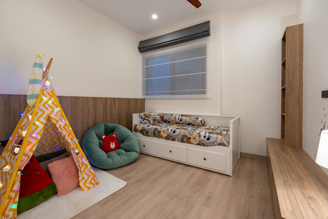 Playful children's bedroom with colorful play tent, comfortable daybed and storage - perfect for kids