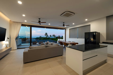 Elegant living room with floor-to-ceiling windows, panoramic sea views and sunset vistas - ultimate relaxation space