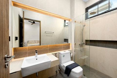 Elegant bathroom with modern vanity, rainfall shower and designer finishes - luxurious comfort