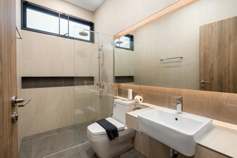 Modern bathroom with walk-in shower, contemporary fixtures and ambient lighting - spa-quality comfort