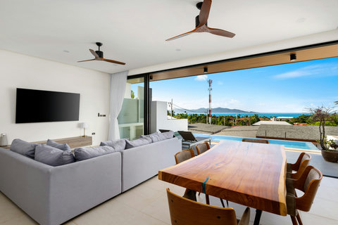 Open-plan living with pool and sea views, modern furniture and natural flow - indoor-outdoor tropical living