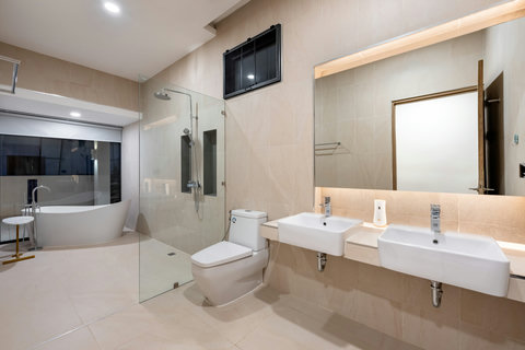 Spacious master bathroom with dual vanity sinks, soaking tub and sleek modern design - luxurious amenities