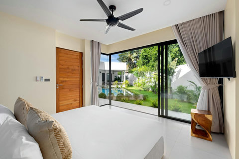 Bright guest bedroom with king bed, garden views and direct pool terrace access - 1 of 3 serene bedrooms