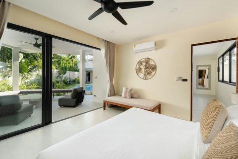 Comfortable guest bedroom with pool terrace access, ceiling fan and tropical garden surroundings - accommodates 6 guests total