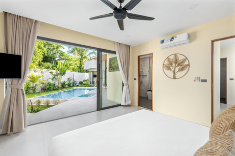 Master bedroom suite with garden-pool views, king bed and direct terrace access for indoor-outdoor living