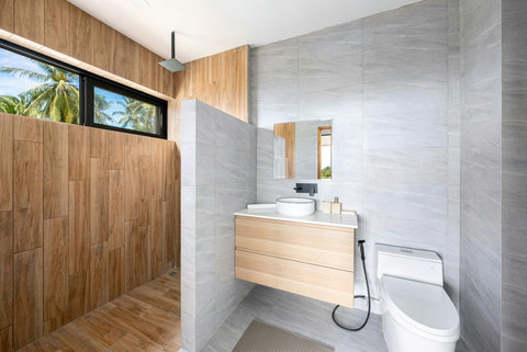 Modern bathroom with wood paneling and contemporary fixtures - stylish luxury villa bathroom