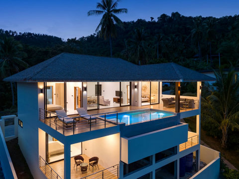 Evening villa exterior view with illuminated pool and modern architecture - luxury Koh Samui hillside retreat