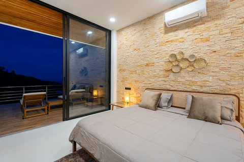 Serene bedroom with pool access and modern design - comfortable accommodation at Sunrise Hill villa