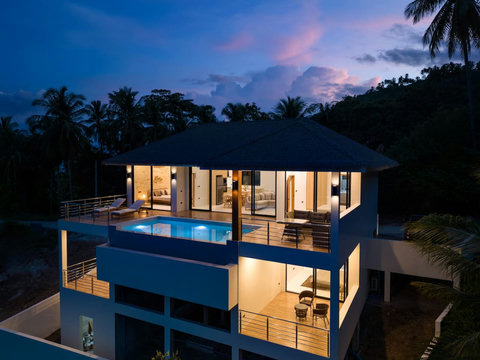 Spectacular evening villa view illuminated with infinity pool and tropical jungle backdrop - Koh Samui
