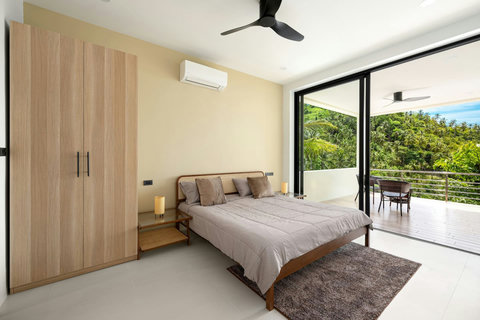 Modern bedroom with garden view terrace access - wood accents and minimalist design luxury villa