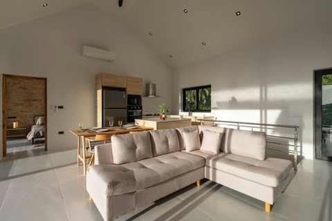 Spacious living area with modern sectional sofa and entertainment center - comfortable indoor relaxation space