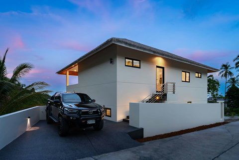 Private parking and villa entrance at twilight - secure and convenient access to your Sunrise Hill retreat