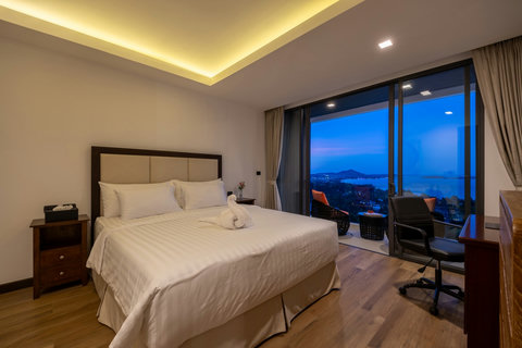 Bedroom at dusk with ambient lighting and sea views at Villa Yoco, Koh Samui