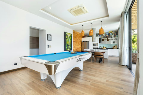 Games room with pool table and open-plan kitchen at Villa Yoco, Koh Samui