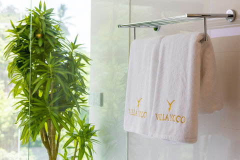 Walk-in shower with branded towels and greenery at Villa Yoco, Koh Samui