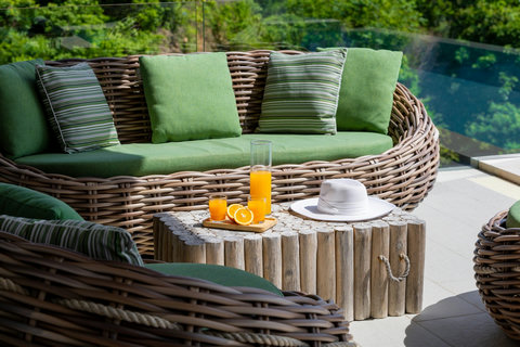 Poolside rattan seating with fresh juice and sun hat at Villa Yoco, Koh Samui