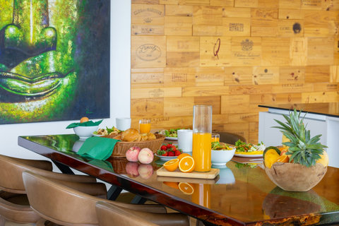 Fresh breakfast spread with fruit and juice on the dining table at Villa Yoco, Koh Samui