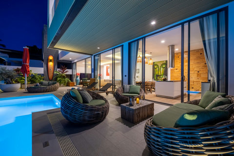 Illuminated poolside lounge chairs at dusk beside the villa at Villa Yoco, Koh Samui