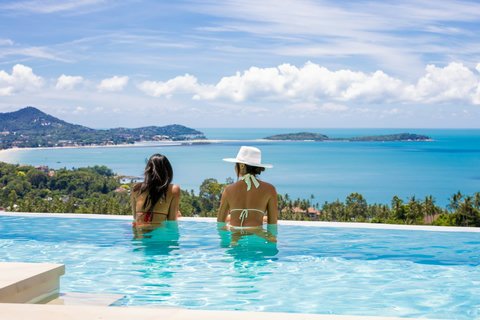 Guests relaxing in the infinity pool overlooking the sea at Villa Yoco, Koh Samui