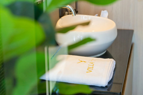 Bathroom with vessel sink, in-room safe and branded towels at Villa Yoco, Koh Samui