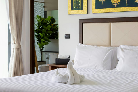 Bright bedroom with artwork and tropical accents at Villa Yoco Koh Samui