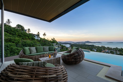 Terrace lounge with sofa and pool at sunset overlooking the sea at Villa Yoco, Koh Samui