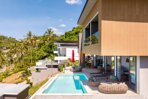Modern villa exterior with private pool and tropical hillside views at Villa Yoco