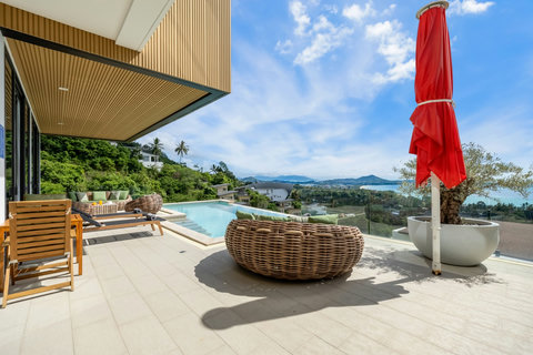 Pool terrace with daybed, parasol and sea views at Villa Yoco, Koh Samui