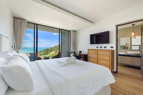 Bedroom with sea-view window and en-suite access at Villa Yoco Koh Samui