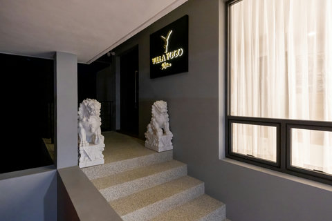 Entrance hallway with staircase and traditional guardian statues at Villa Yoco, Koh Samui