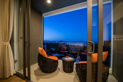 Private balcony seating at dusk overlooking the coastline at Villa Yoco, Koh Samui