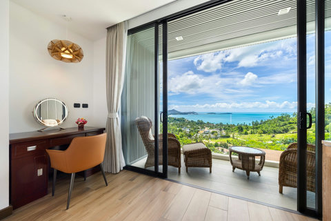 Dressing area with sea-view balcony access and lounge seating at Villa Yoco, Koh Samui