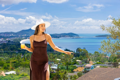 Guest enjoying a drink with panoramic sea views at Villa Yoco, Koh Samui