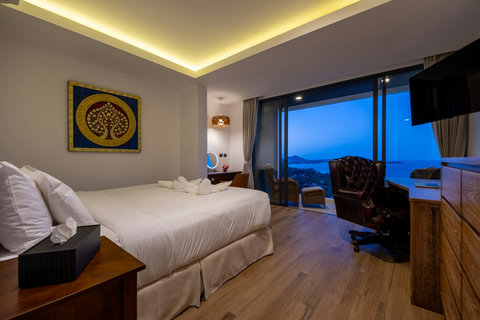 Elegant bedroom with ambient lighting and evening sea views at Villa Yoco Koh Samui