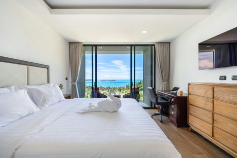 Bedroom with sea-view sliding doors, work desk and private balcony at Villa Yoco, Koh Samui