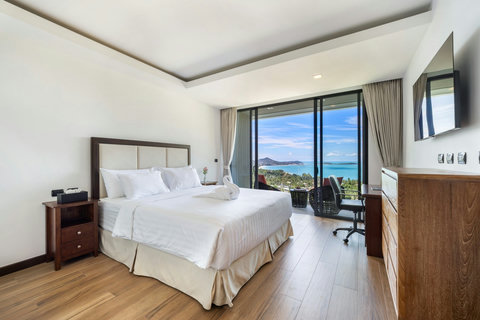 Bright bedroom with sea-view windows, desk and en-suite access at Villa Yoco, Koh Samui