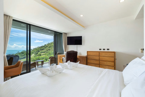 Spacious bedroom with floor-to-ceiling sea-view windows and dresser at Villa Yoco, Koh Samui