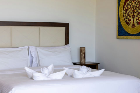 Twin bedroom with decorative towel art and cozy furnishings at Villa Yoco, Koh Samui