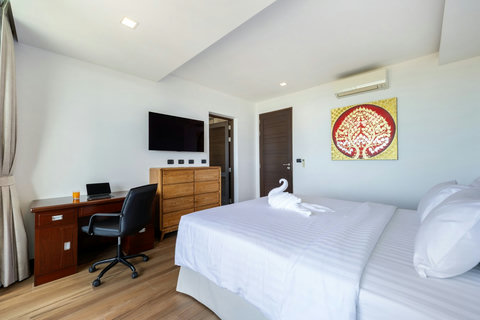 Spacious bedroom with work desk and Thai-inspired art at Villa Yoco Koh Samui