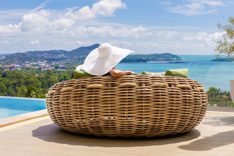 Guest relaxing on a round daybed with panoramic sea views at Villa Yoco, Koh Samui