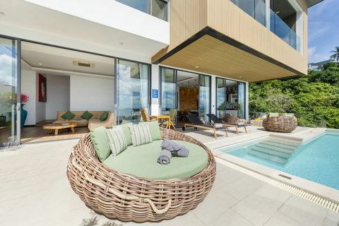 Round rattan daybed beside the pool and covered terrace at Villa Yoco, Koh Samui