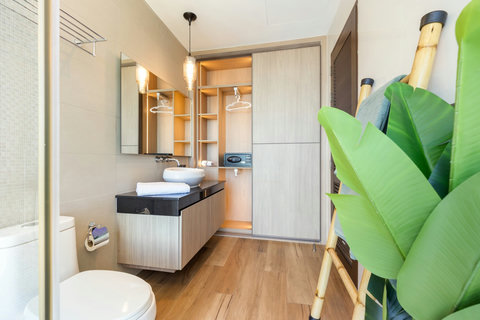 Modern en-suite bathroom with double vanity and wooden flooring at Villa Yoco, Koh Samui