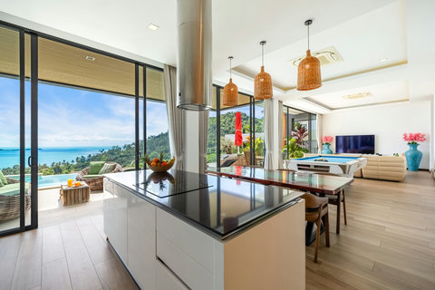 Open-plan kitchen and dining with sea views and pool table at Villa Yoco Koh Samui